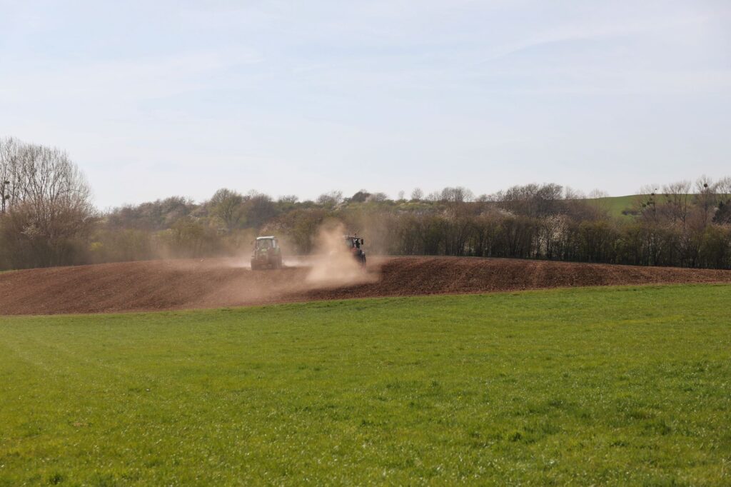 tractor plowing field on sunny spring day